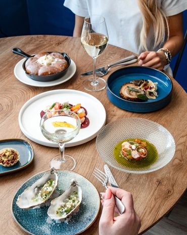 Elegant dining with seafood and wine on a wooden table.