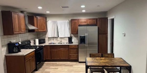 Modern kitchen with wooden cabinets and stainless steel appliances.
