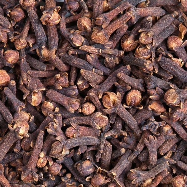 Close-up of dried cloves, a dark brown spice with bulbous heads.