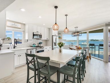 Bright modern kitchen with large island and waterfront view.