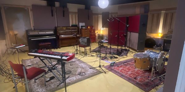 Live room at Blank Studios with various instruments and microphones set up.