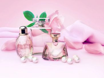 Beautiful perfume bottles and pink background