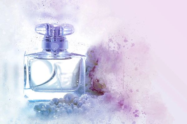 perfume bottle with white crystals on blue background