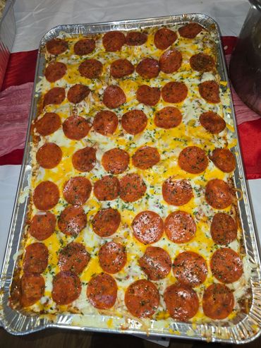 Large rectangular pepperoni pizza with melted cheese and herbs.