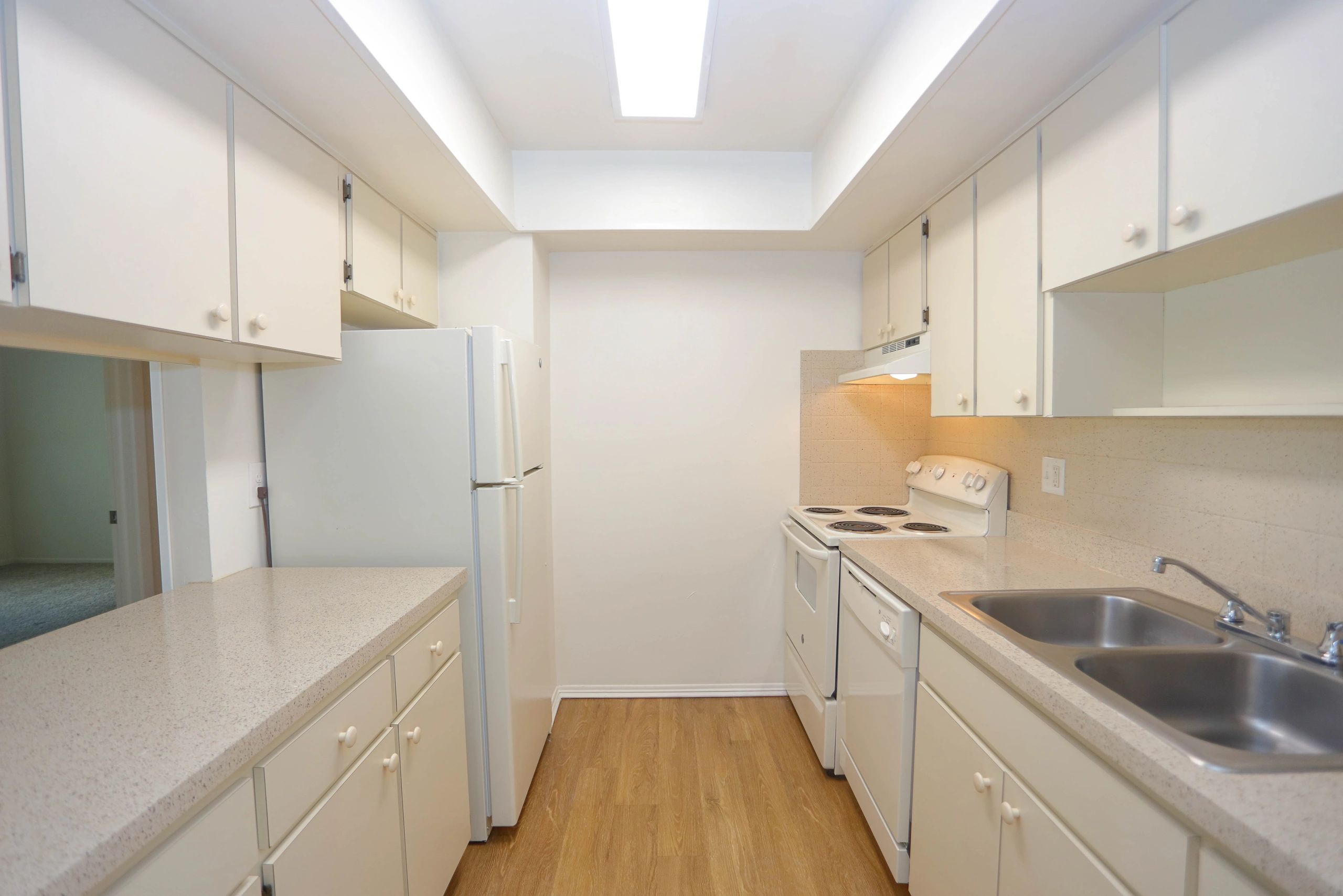 First floor kitchen with plank flooring.