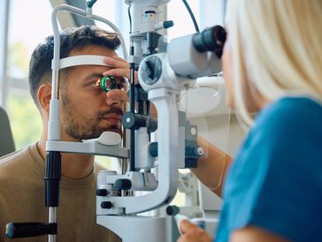A man is getting tested for his eyes