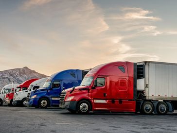 Semi trucks against mountain landscape