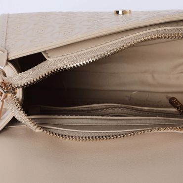 Close-up of an open beige handbag showing inner compartments and zipper.