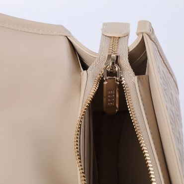 Close-up of a beige handbag zipper and interior.