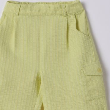 Light green textured pants with an elastic waistband and pockets.