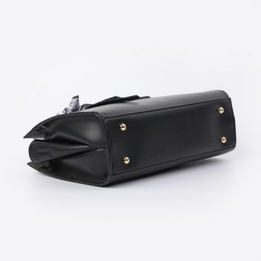 Black leather handbag with gold studs on the bottom against a white background.
