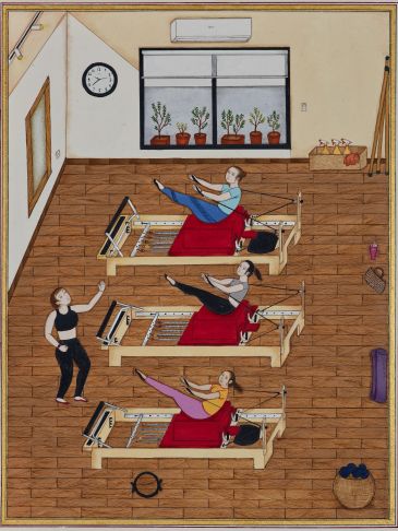 Three women exercising on Pilates reformer machines.