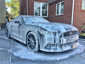 Ford Mustang covered in foam during an auto detail