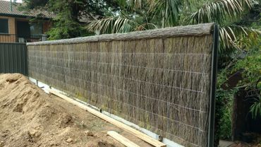 New Brush fence on top of a retaining wall