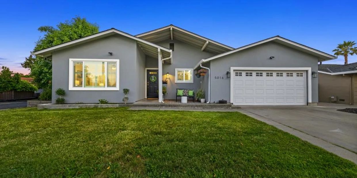 Modern single-story gray house with a front lawn and garage.