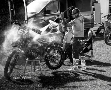 Man cleaning Moto-X bike after use