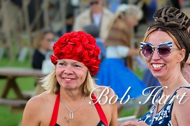 Three women in vintage swimsuits and swim caps enjoying a sunny day outdoors.