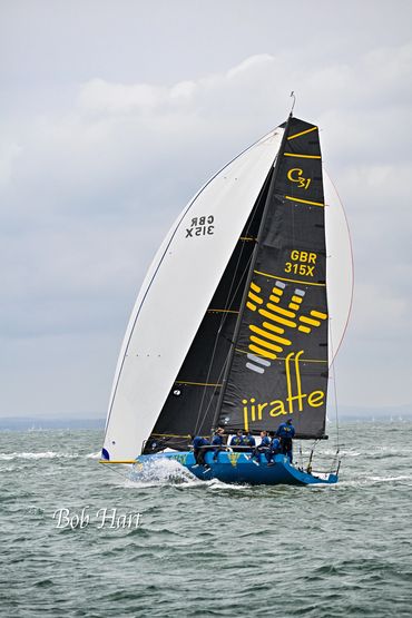 Sailboat named Jiraffe sailing on the sea.