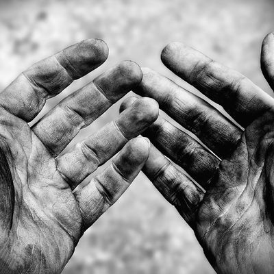 Close-up of dirty, weathered hands.