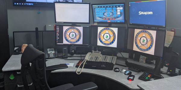 Dispatch computer set up with six screens.