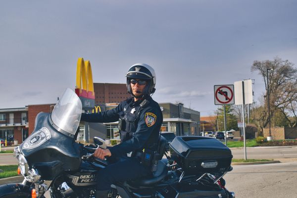 Officer on Motorcycle turning into Police Department.