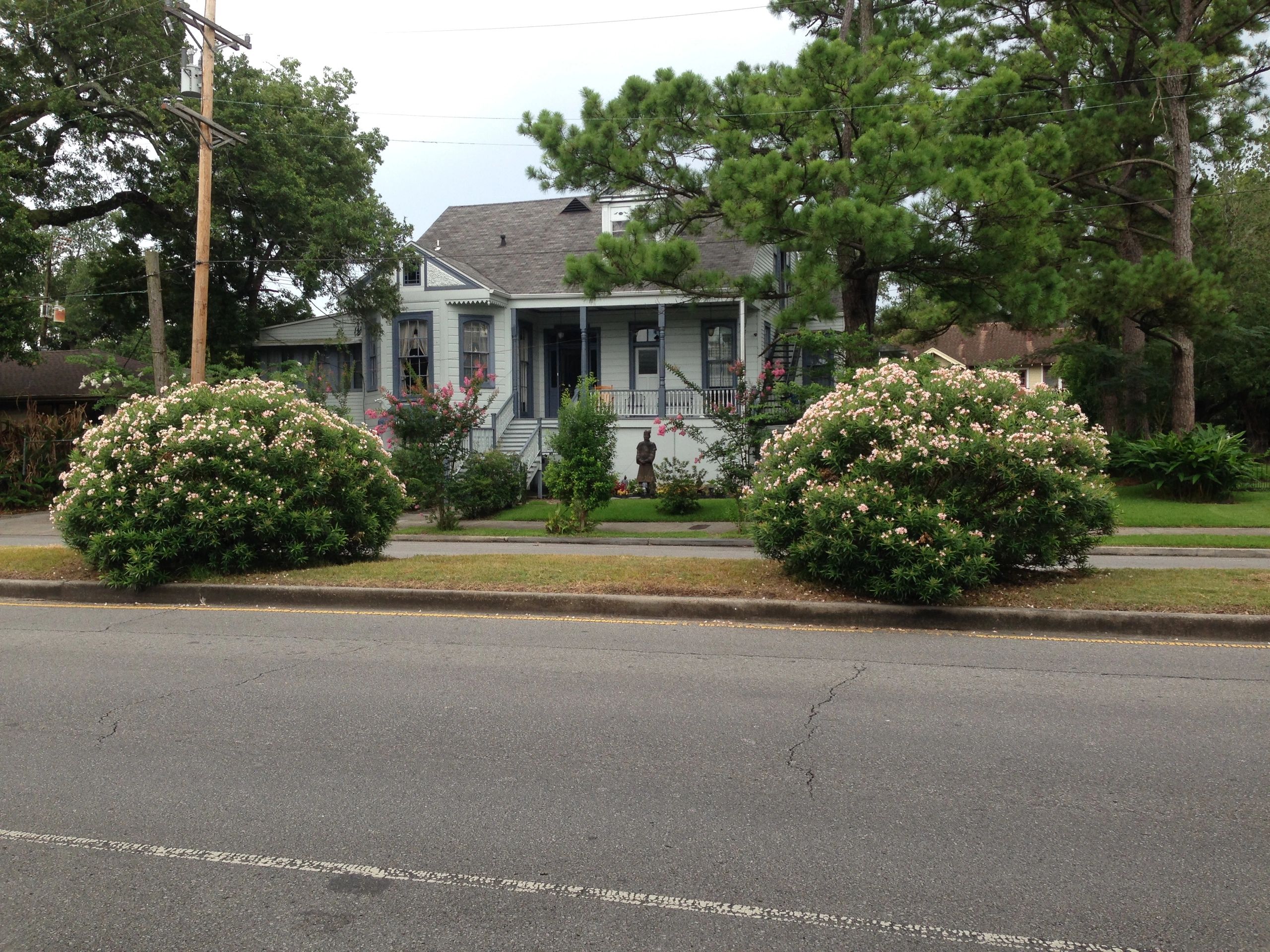 a small house with a porch and trees