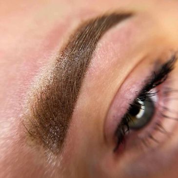 Close-up of a shaped and filled eyebrow with eye partially visible.