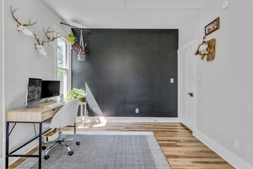 Office walls painted with Benjamin Moore Owl Gray and Sherwin Williams Tricorn Black on accent wall