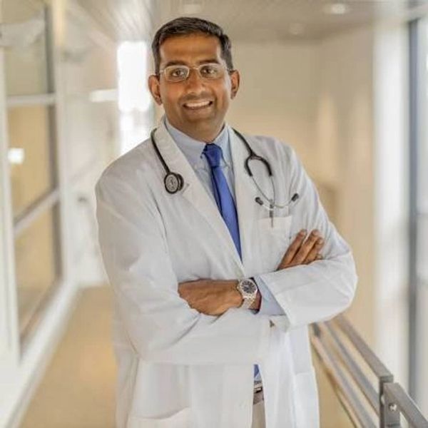Confident doctor in white coat with stethoscope.