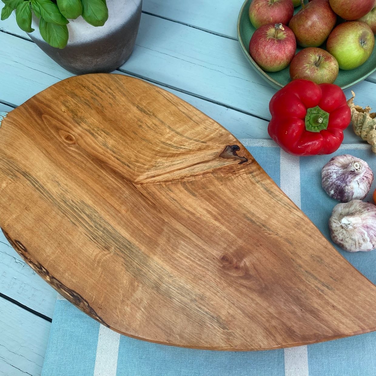Chopping board on table with fruit and vegetables 