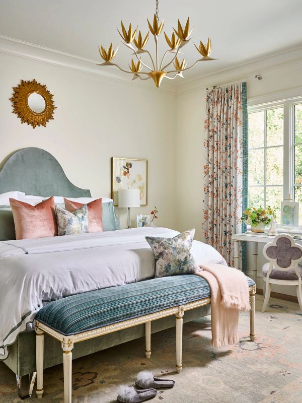 Elegant bedroom with pastel decor and floral accents.