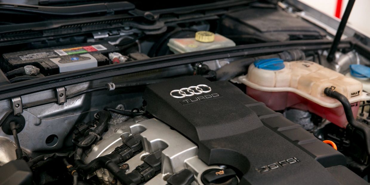 Audi engine compartment with turbo and 2.0 TFSI details.