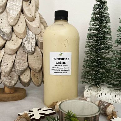 A bottle of Ponche de Crème with holiday decor.