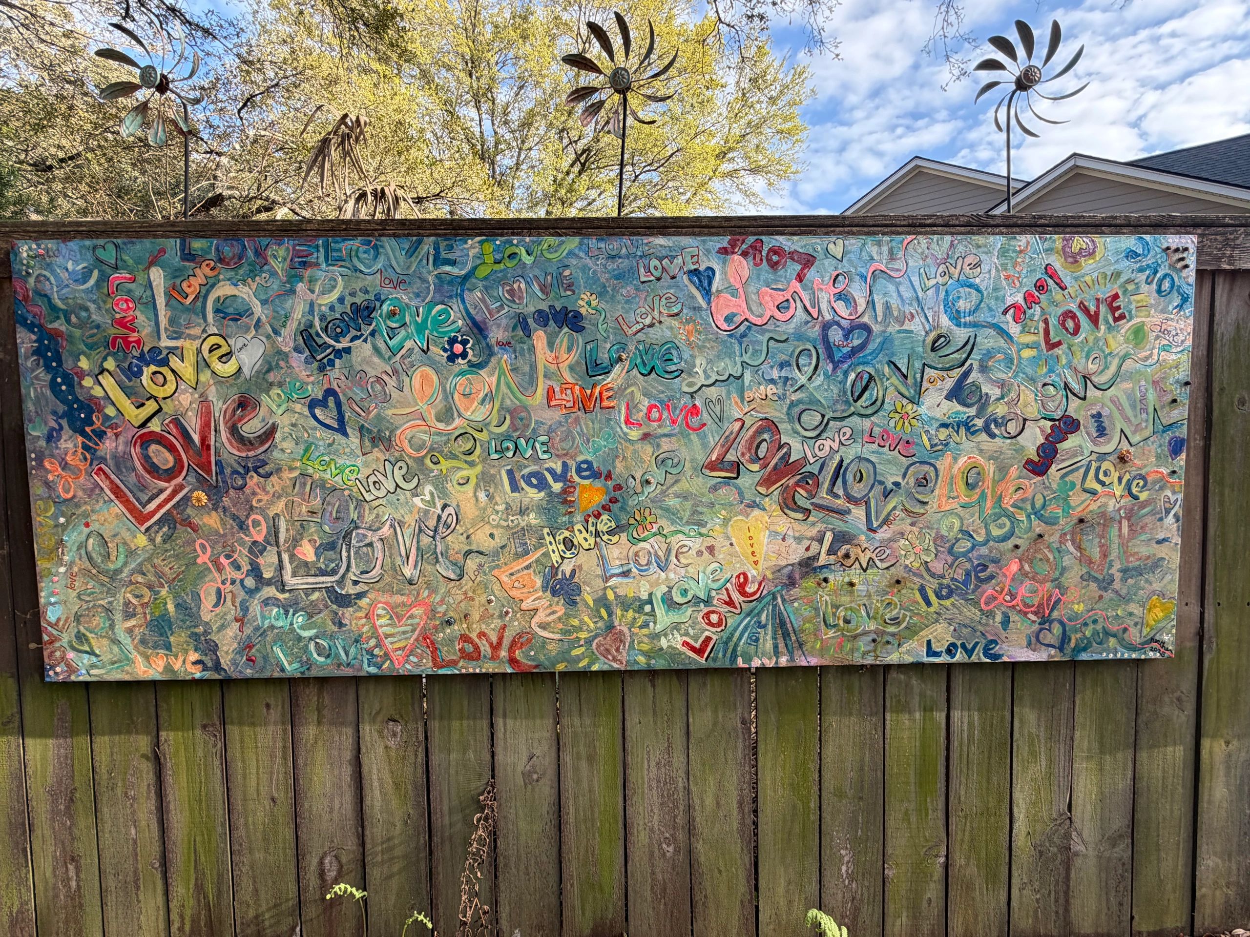 Colorful mural filled with the word 'love' in various styles and colors.