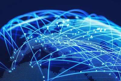 Glowing blue network lines connecting points on a digital globe.