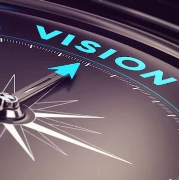 Compass needle pointing to the word 'VISION'.