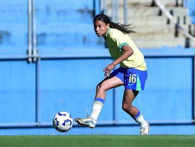 Youth soccer player controlling the ball on the field.