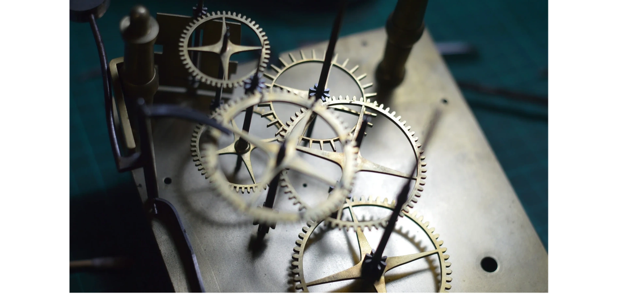 antique clock movement with brass wheels and gears