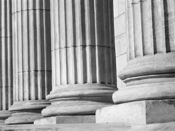 Legal pillars outside of a court house. These are large Grey cement pillars