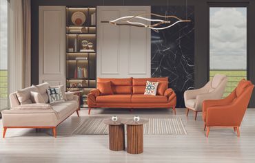 Modern living room with orange and beige sofas and artistic lighting.