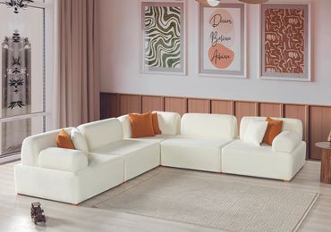 Modern white sectional sofa with colorful cushions in stylish living room.
