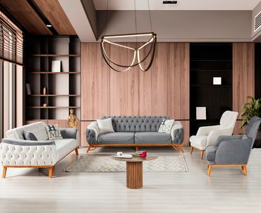 Modern living room with grey and white sofas and wooden accents.