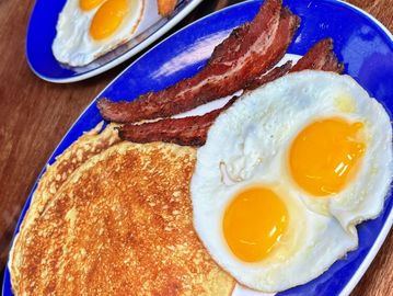 Pancake breakfast with two eggs any style with your choice of house smoked bacon, sausage or ham.