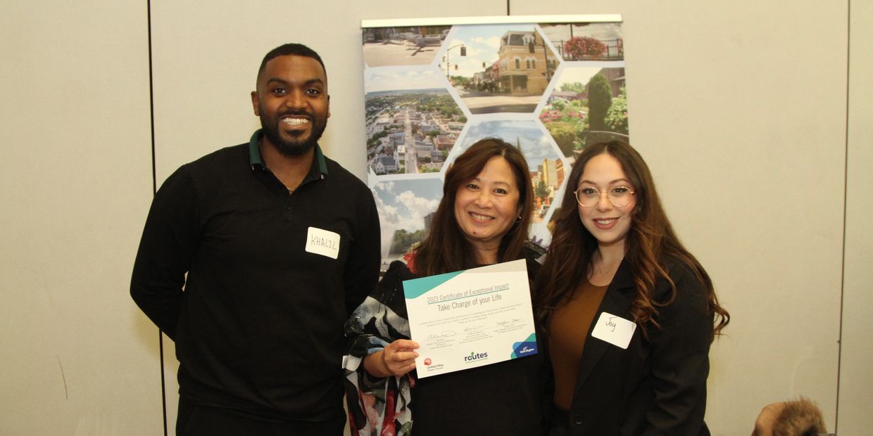 Jacinta receiving recognition Certificate of Exceptional Impact