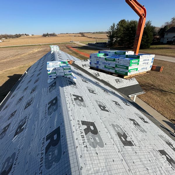 Roof replacement in progress by D&B Roofing using premium synthetic underlayment and Malarkey Vista Class 4 impact-resistant shingles for superior durability and protection in the Quad Cities.