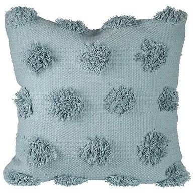 Light blue textured pillow with pom-pom accents.