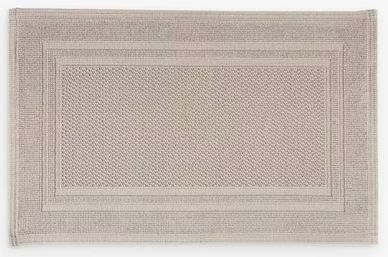 Rectangular beige woven rug with textured border and center pattern.