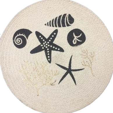 Round white mat with black sea-themed prints including starfish and shells.