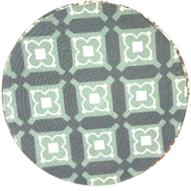 Close-up of a circular fabric with a green and gray geometric pattern.