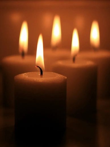 Candle trio ablaze in a serene setting

